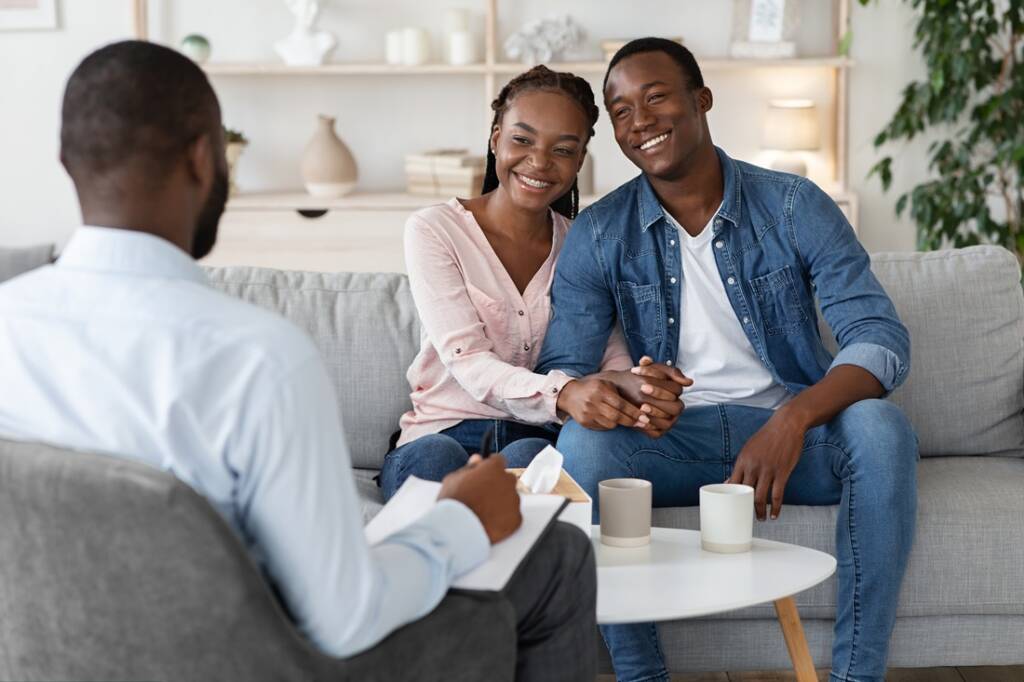Happy African couple in marital therapy
